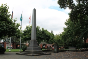 A photo of the cenotaph and flags in Veteran's Park next to City Hall