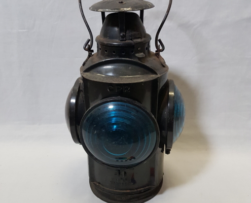 Dark metal lantern with bail handle and a large blue bulb on each side