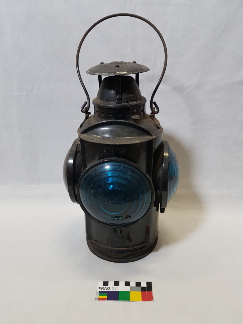 Dark metal lantern with bail handle and a large blue bulb on each side